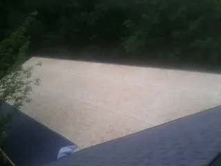 New OSB roof sheathing installed beside an existing shingle roof in Richmond
